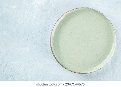 An empty green plate, shot from above on a slate background with a place for text - Powered by Shutterstock