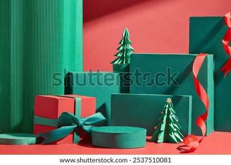 Empty green round platforms for displaying products, are placed next to green rectangular podiums, decorated with paper Christmas trees, red gift boxes, and red ribbons on a bright red background.