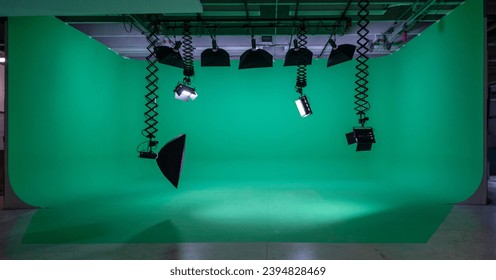 Empty green screen studio with professional lighting equipment