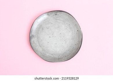 Empty grey plate   on pink backdrop. Food background for menu, recipe book. Table setting. Flatlay, top view, mockup.