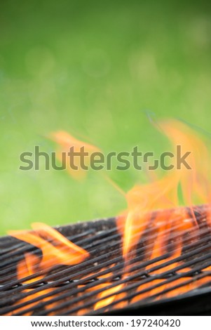 Empty grill on garden with burning embers