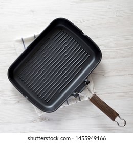 Empty Grill Pan On A White Wooden Background, Top View. Overhead, From Above, Flat Lay. 