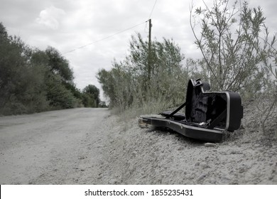 Empty Guitar Case Found In A Dusty Road