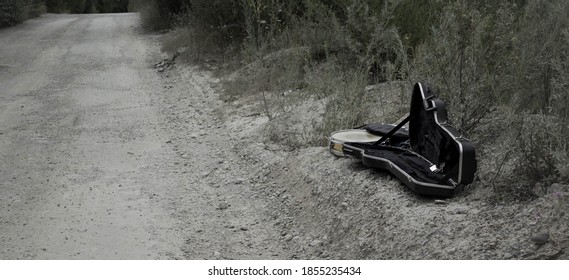 Empty Guitar Case Found In A Dusty Road