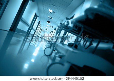 Empty gurney in a long corridor.