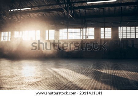 Empty, gym and interior space or dark room with window and light flare for exercise, training and fitness workout. No people, sports club and floor layout of exercising venue, facility and gymnasium