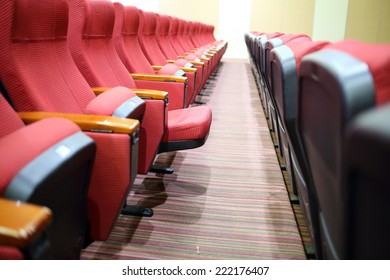 Empty hall for presentation with red armchairs. 