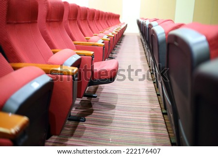 Empty hall for presentation with red armchairs. 
