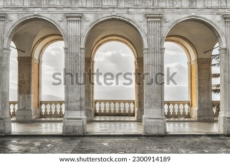 The empty hallway with arches and columns.