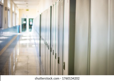 Empty hallway corridor of a high school or college closed during COVID-19 (Coronavirus). Lockers blurred into lonely hallway. - Powered by Shutterstock