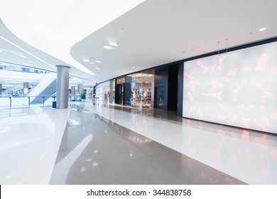 empty hallway with a huge billboard and abstract ceiling in modern shopping mall - Powered by Shutterstock