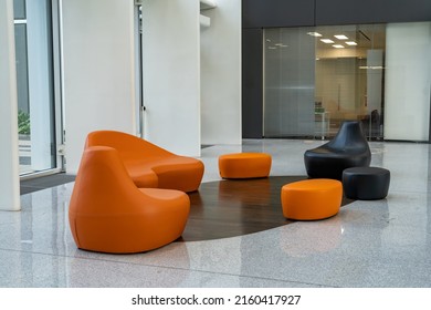 Empty hallway with orange modern chairs in office. Interior of modern entrance lobby in modern office building - Shutterstock ID 2160417927