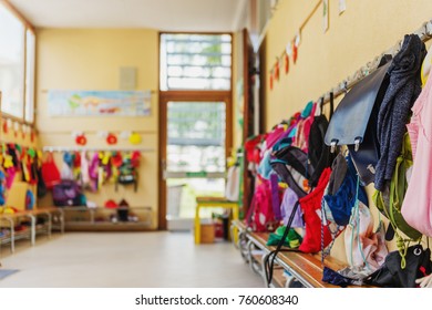 Empty hallway in the school, backpacks and bags on hooks, bright recreation room - Powered by Shutterstock
