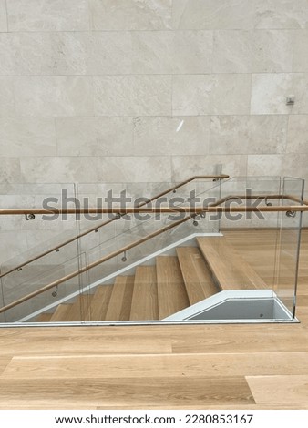 Empty hallway staircase stairwell landing oak hardwood floor glass partition hand rail texture background marble tile