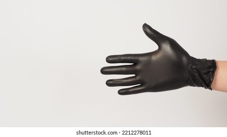 Empty Hand Is Wear Black Latex Gloves On White Background.