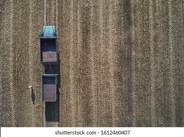 Empty harvester truck with trailer in field. Aerial view