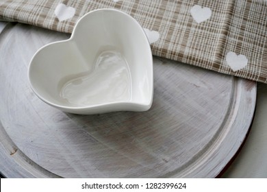 Empty  heart shaped dish on a wooden tray