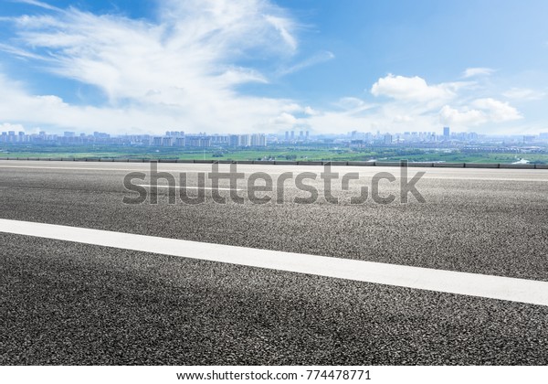 Empty highway asphalt road and beautiful sky\
clouds landscape
