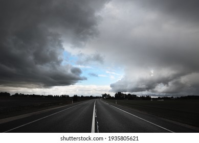 Empty highway (asphalt road) through the fields. Dramatic sky before the rain and thunderstorm.   - Powered by Shutterstock
