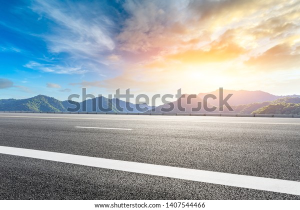 Empty highway road and beautiful mountain with\
clouds landscape