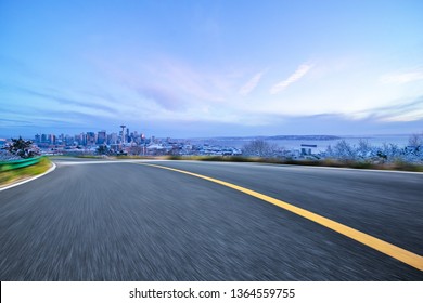 Empty Highway Road With Seattle Skyline Background At Night.