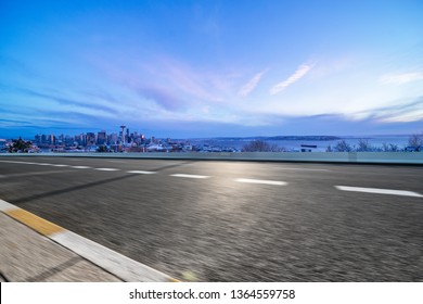 Empty Highway Road With Seattle Skyline Background At Night.