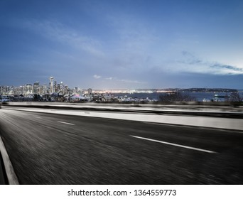 Empty Highway Road With Seattle Skyline Background At Night.