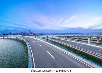 Empty Highway Road With Seattle Skyline Background At Night.