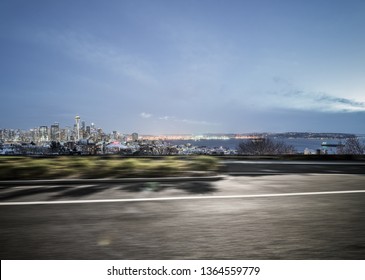 Empty Highway Road With Seattle Skyline Background At Night.