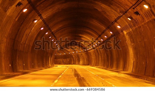 Empty highway road\
tunnel. Dark tunnel