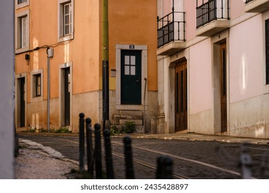 Empty historic cobblestone street with tram tracks in Lisbon, Portugal - Powered by Shutterstock