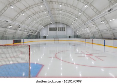 empty hockey field, arena with ice and markings and gates