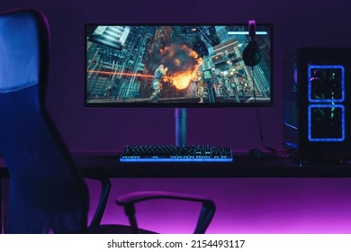 Empty home gaming studio of cyber sportsman in neon lights. Professional gaming setup for playing online video games and live streaming. Shooters, cyber sport, esport concept