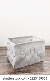 Empty Home Storage Basket Made Of Soft Grey Felt Material. Side View, Square Pattern, Copy Space