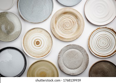 Empty Homemade Pottery Plates On White Background. Top View