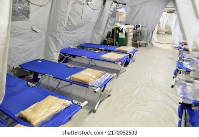 Empty hospital field tent for the first AID, a mobile medical unit of red cross for patient with Corona Virus. Camp room for people infected with an epidemic. Alert Omicron 5.