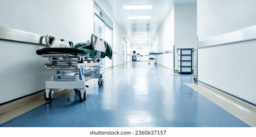 Empty hospital hallway with bed - Powered by Shutterstock