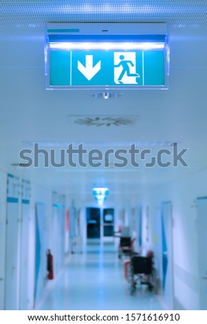 Empty hospital hallway. Exit sign. Medical healthcare concept.