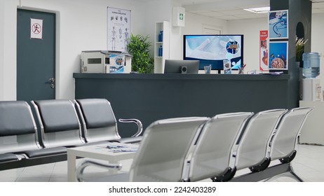 Empty hospital waiting room in lobby with reception counter at medical facility, used to help patients with appointments and healthcare insurance. Medical waiting area with front desk. - Shutterstock ID 2242403289
