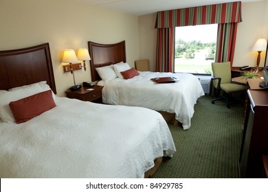 An Empty Hotel Or Motel Room With Two Beds