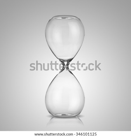 Empty hourglass on gray background