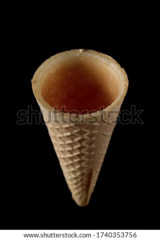 Empty ice cream cone isolated on black background with clipping path