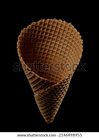 Empty ice cream cone isolated on black 