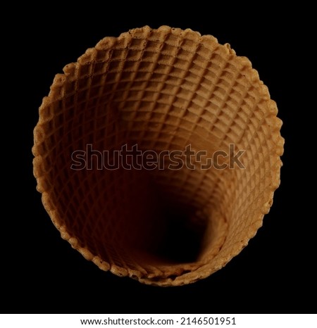 Empty ice cream cone isolated on black, top view 