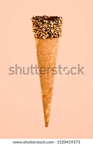 Similar – Ice cream cone with unpeeled peanuts on pink background