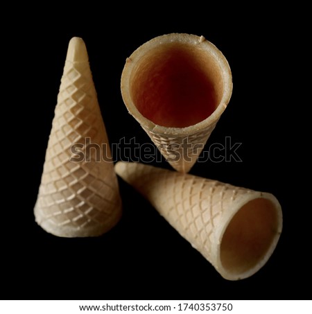 Empty ice cream cones isolated on black background with clipping path