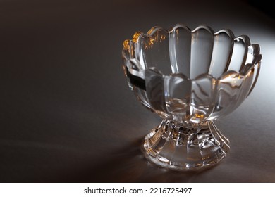 Empty  Ice Cream Glass Bowl, Sundae Glass, Or Dessert Cup With Dark Background And White Light