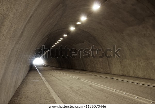 empty illuminated car or road tunnel,\
underpass or underground\
passageway