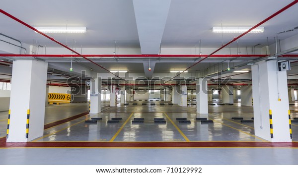 Empty indoor car parking\
space / lots.