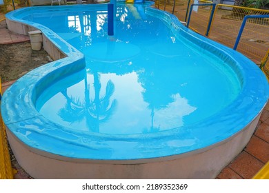 Empty Indoors Children Swimming Pool, Public Swimming Pool In Fitess Club. Children Swimming Pool With Sunny Reflections